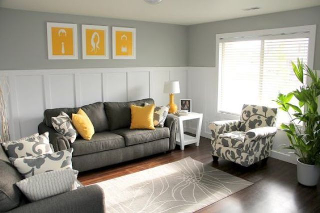 11 charcoal grey sofa and chair, yellow pillows and art pieces .