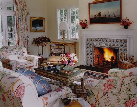delft-tile-fireplace-chintz-sofa-chairs-sea-art - The Glam P