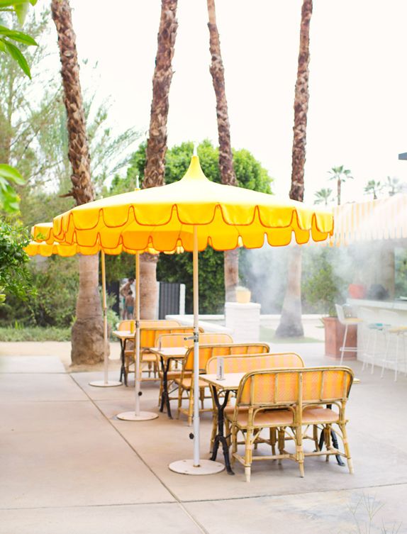 vintage yellow umbrellas are perfect for a drink outside .