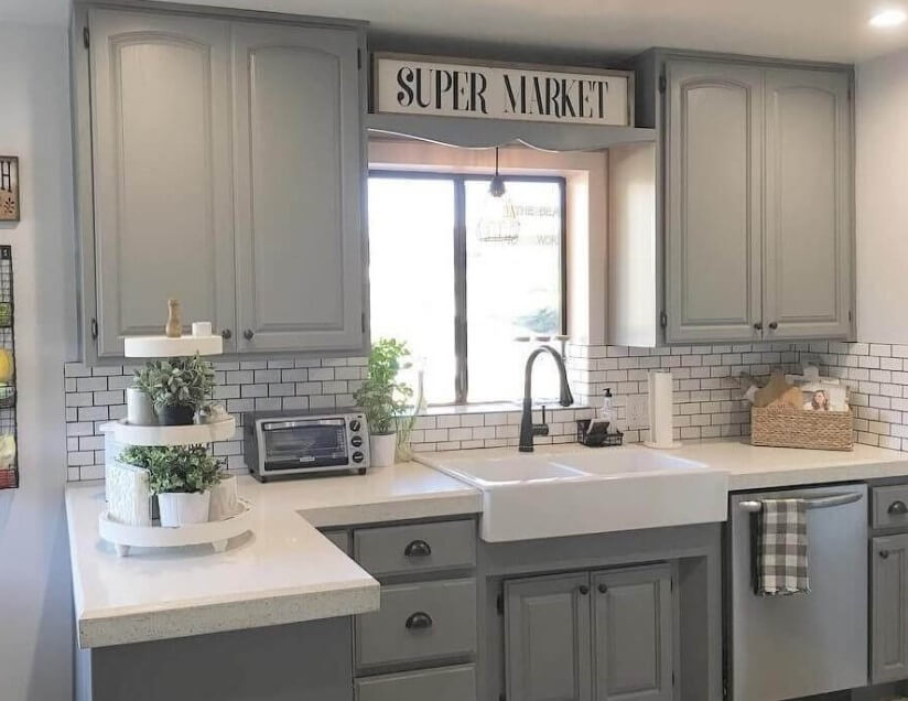 Kitchen cupboard in grayscale with subway tile back wall