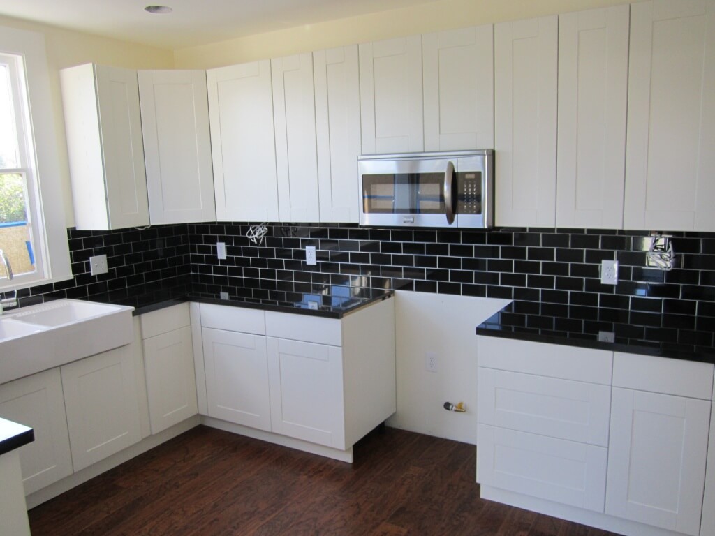 Kitchen back wall with black and white tiles