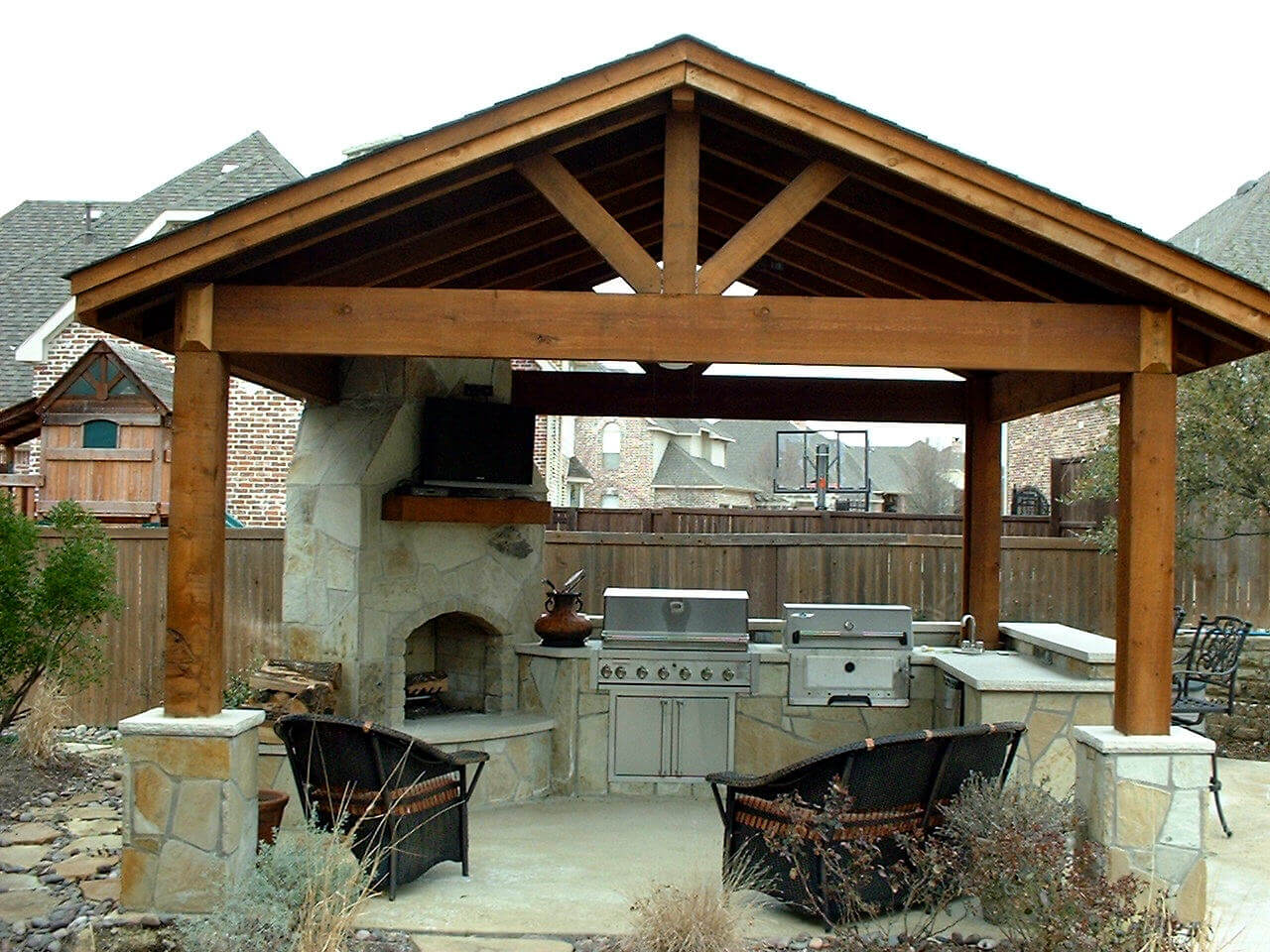 Outdoor kitchen with stone fireplace
