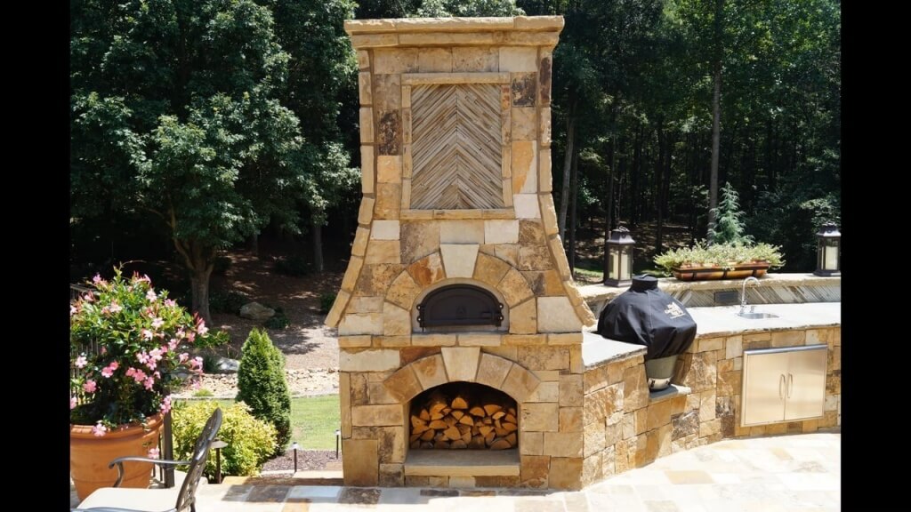 Outdoor kitchen with a tasteful fireplace