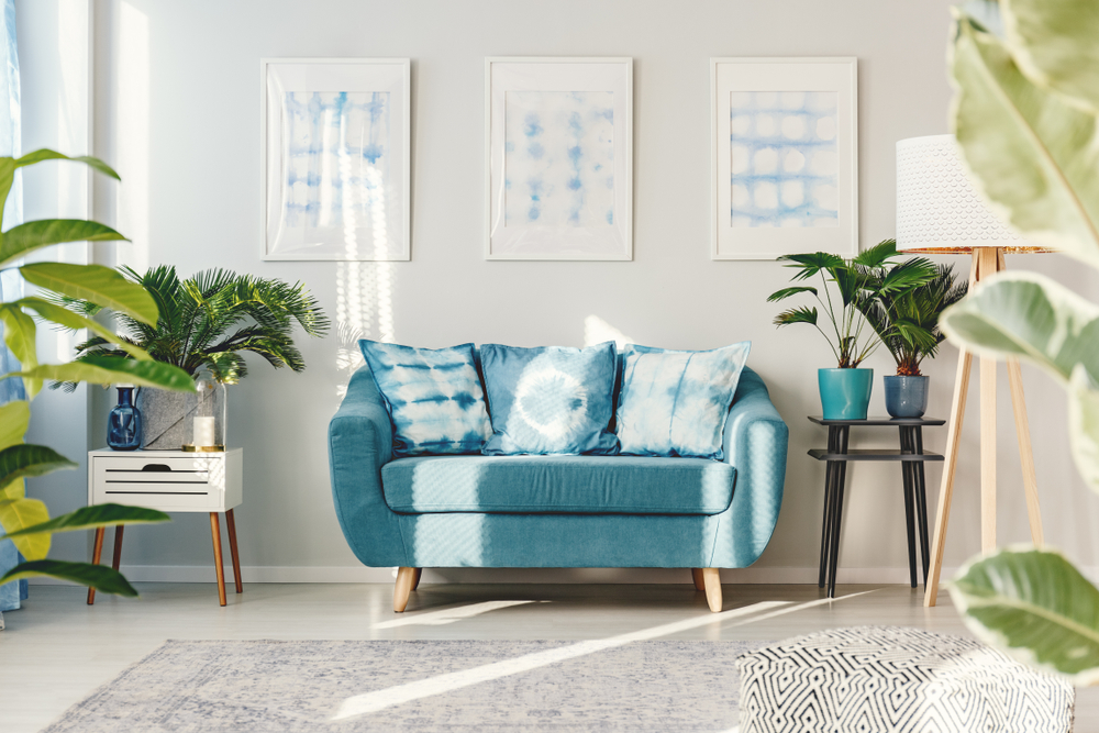 Bulky blue mini couch in a living room