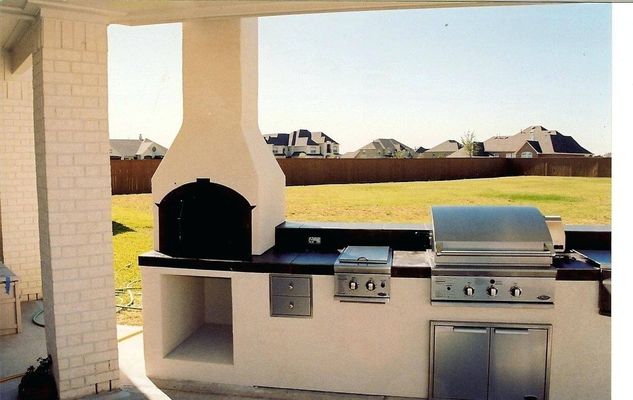 Outside kitchen with modern fireplace