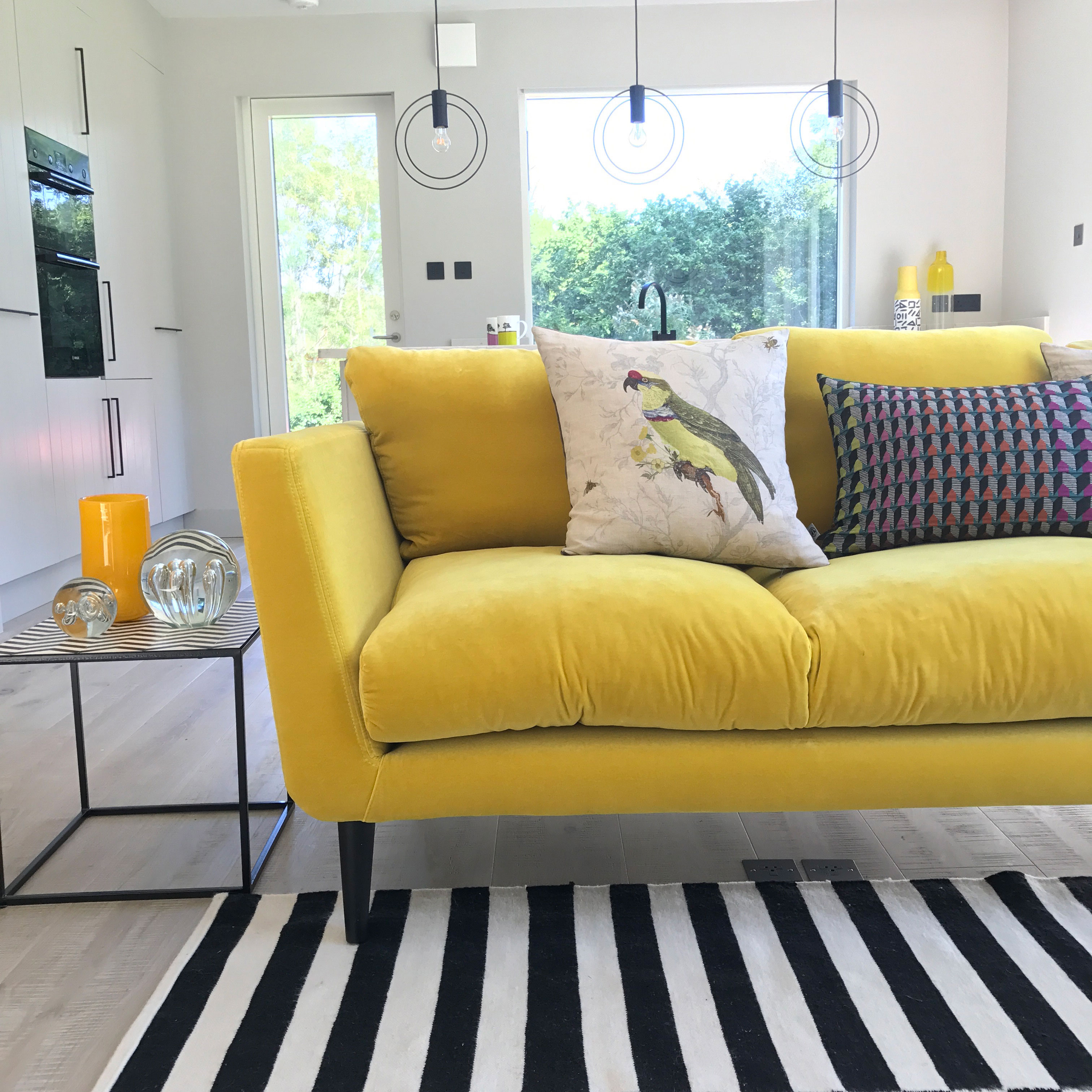 Velvet yellow sofa in the extension of interior designer Sophie Robinson.  black QXGSSEH