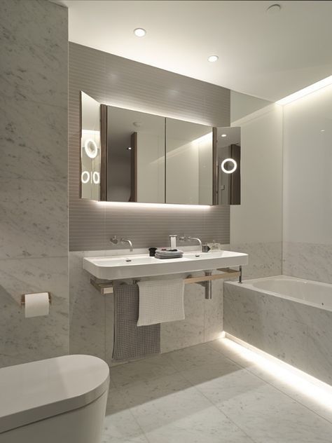 Cool white LED light strips look amazing in this modern bathroom.