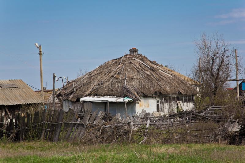 Abandoned Russian Village.  Ruins of rural house with thatched roof.