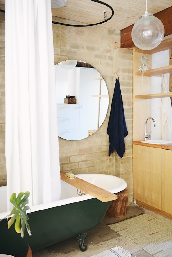 Chic brick bathroom design with a retro green bathtub - DigsDi