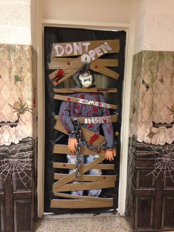 creepy zombies in door decor |  Halloween front door decorations.