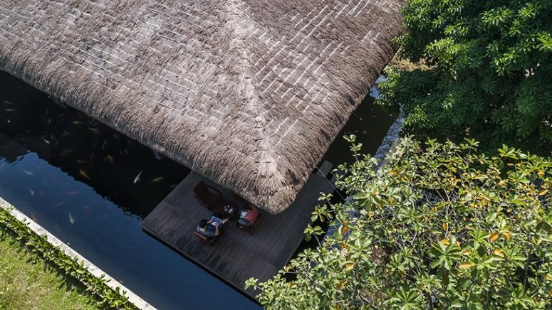 House thatched roof and pond