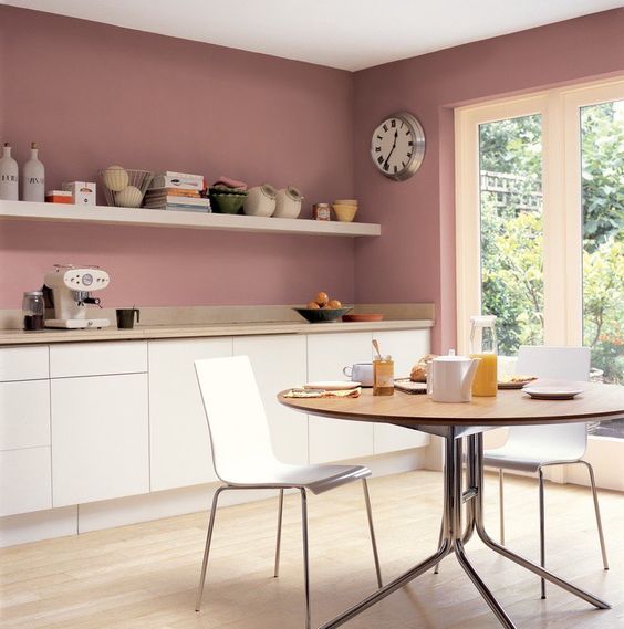 Pink walls and cream cabinets create a very chic combination and a strong girlish atmosphere in the room