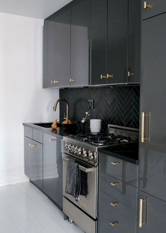 A modern black kitchen refreshed with white finishes and gold handles throughout adding a touch of glamour