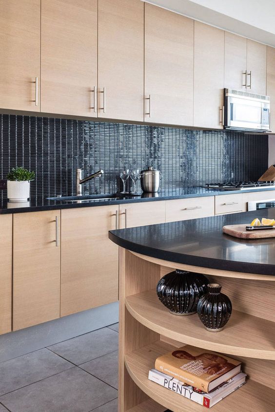 an MDF kitchen with glossy tiles on the back and black worktops, plus a matching kitchen island