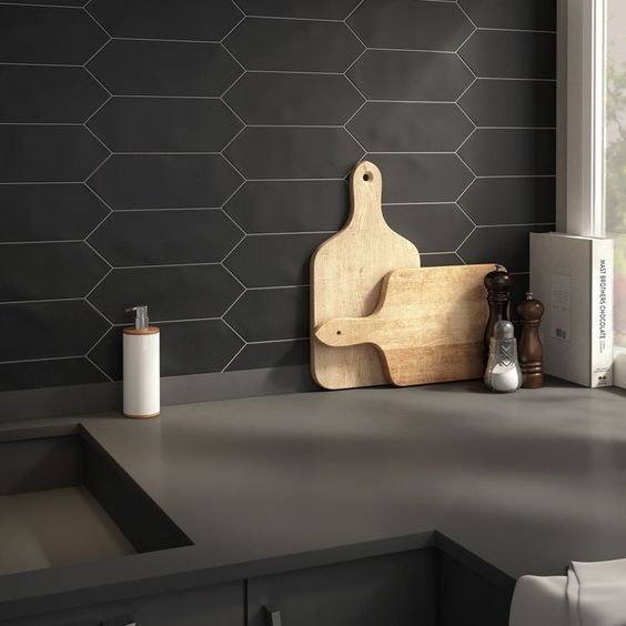 A black honeycomb tile backsplash with white grout is a creative idea that suits minimalist spaces