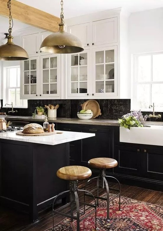 a vintage-inspired kitchen with black shaker cabinets, white countertops and a black zellige tile backsplash, and metal pendant lamps