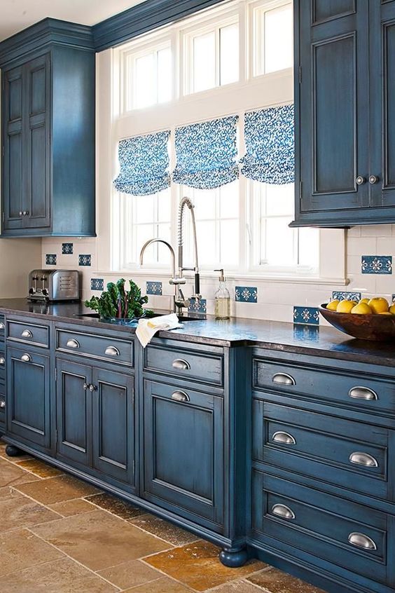Vintage blue chalkboard painted cabinets and printed Roman blinds