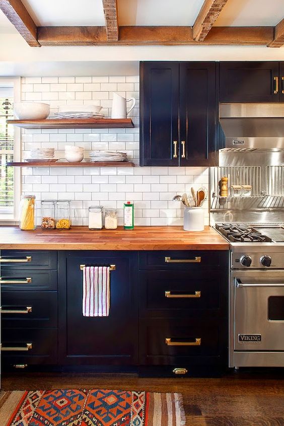 Dark blue cabinets and wooden countertops provide contrast