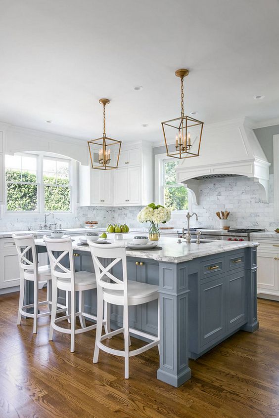 A vintage kitchen gets a coastal touch with a light blue kitchen island