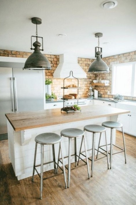 A farmhouse kitchen with a yellow brick backsplash looks cool and interesting, and metal accents add a retro feel