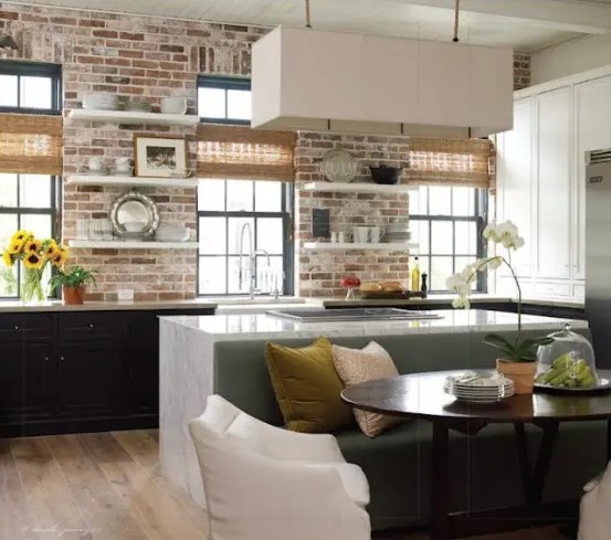 Whitewashed brick contrasts with the black cabinets while highlighting them