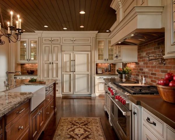 a neutral kitchen with shaker-style cabinets, a red brick backsplash, a stained kitchen island with a stone countertop, and vintage appliances