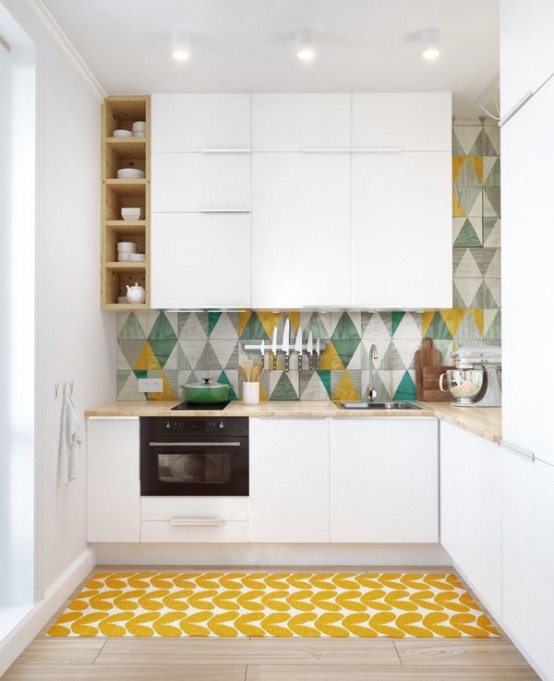 a modern white kitchen with bright accents, featuring sleek cabinets, a colorful geotile backsplash, and a bright geometric rug