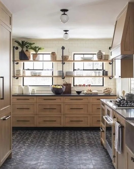 A stained kitchen with shaker-style cabinets, black stone countertops and black handles, and long open shelves instead of upper cabinets is cool