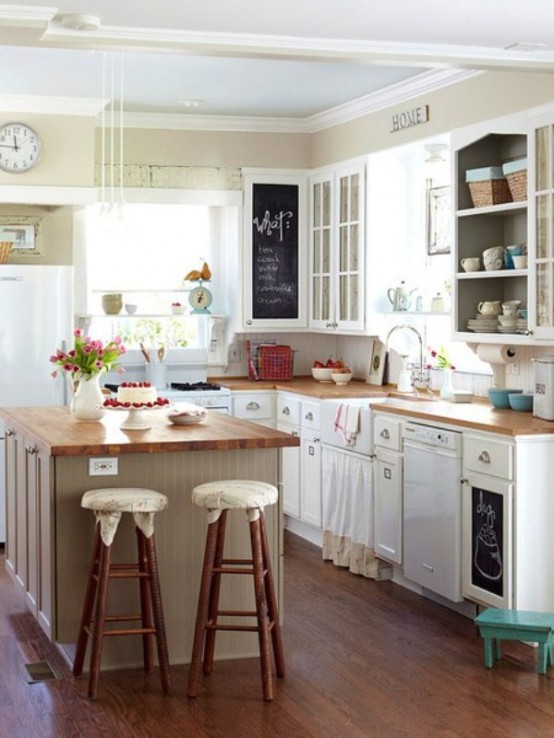a small and cozy farmhouse kitchen with white cabinets and wooden countertops, stools and lots of natural light