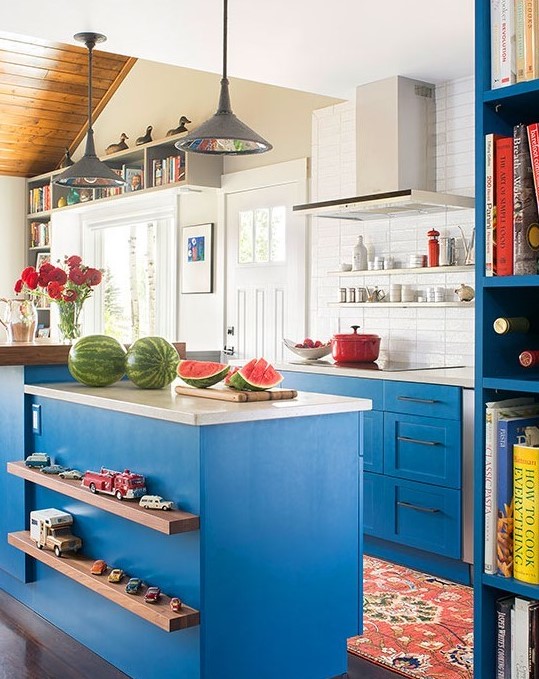 Bright sky blue paint on traditional Shaker-style cabinets and a variety of finishes make this versatile kitchen attractive