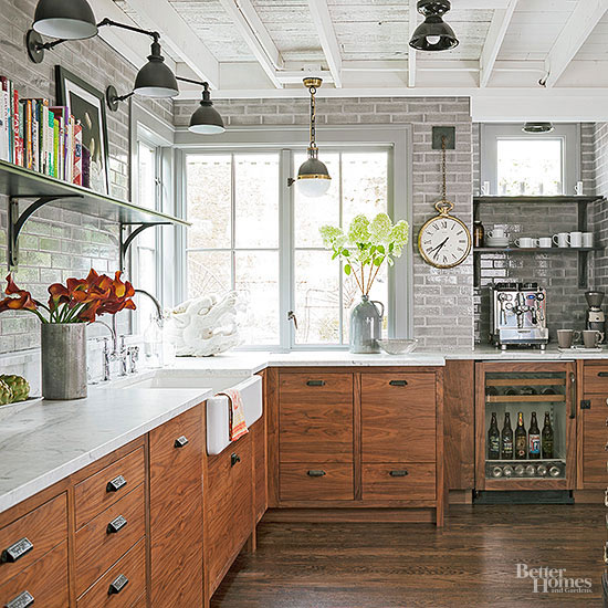 A modern, industrial kitchen with rustic wood cabinets, white marble countertops, and high-tech appliances