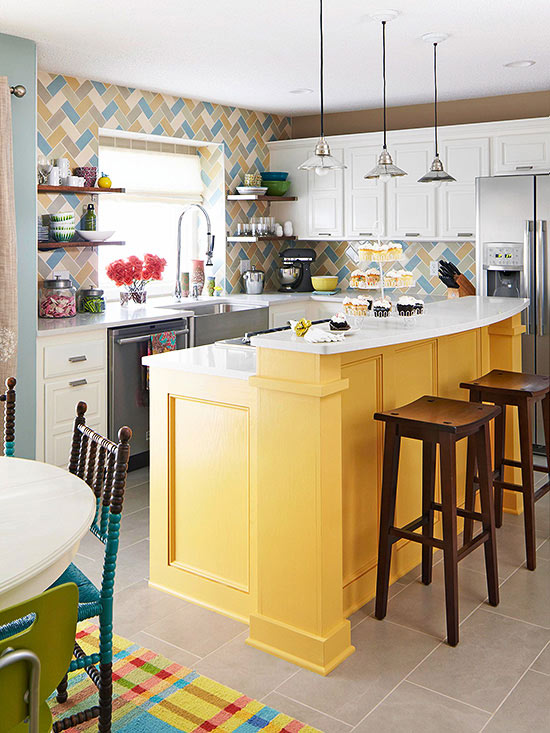 Farmhouse-style cabinets in white and yellow paired with a bright herringbone tile backsplash and industrial pendant lamps