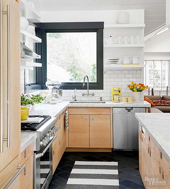 Modern cabinetry, white subway tile, and classic marble countertops paired with dark accents create a modern and retro look
