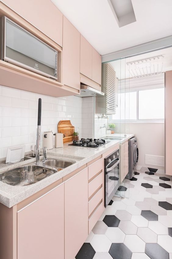 a modern blush kitchen with sleek cabinets, white stone countertops, a white subway tile backsplash, and a hexagonal tile floor