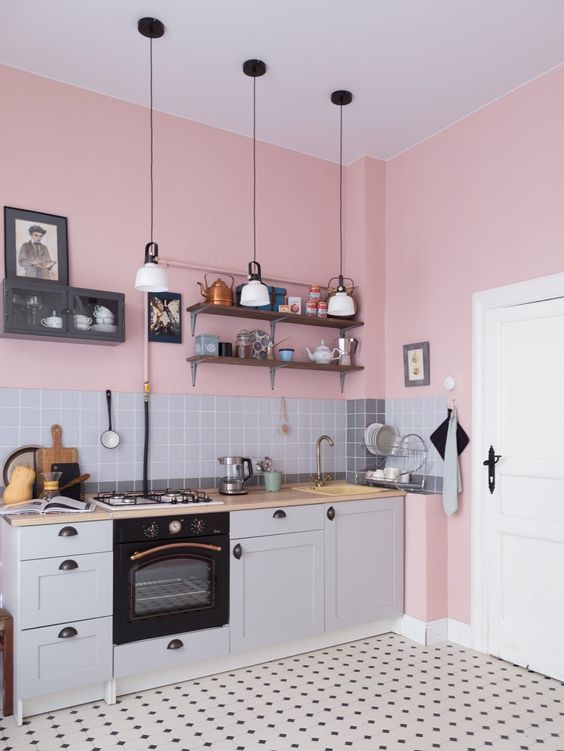 Pink walls and gray tones are a perfect combination for any kitchen, and black accents add depth