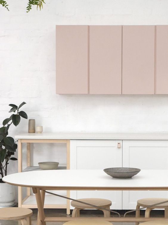 A chic, modern kitchen with white and pink cabinets highlights the two-tone trend