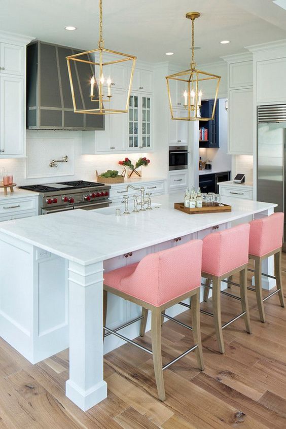 Pink stools add color to the traditional white kitchen and provide a modern touch