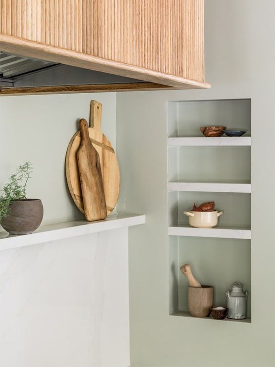 Niche shelves used for storage and display in the kitchen look very elegant and seamless and allow you to save table space