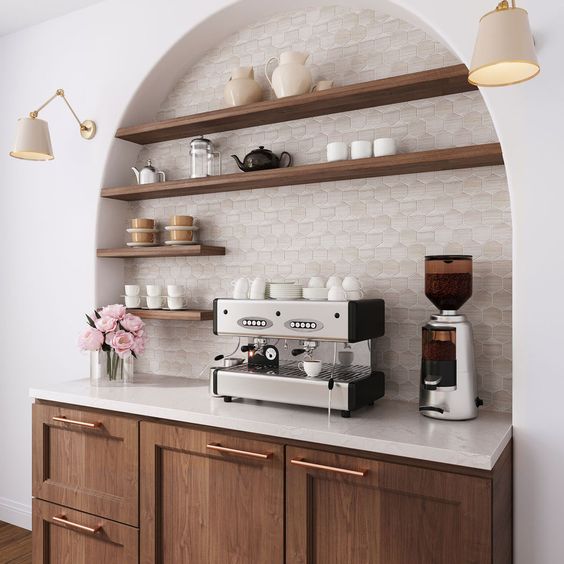 An arched hex tiled alcove with open stained shelves and a cabinet makes a beautiful home coffee and tea bar that looks great