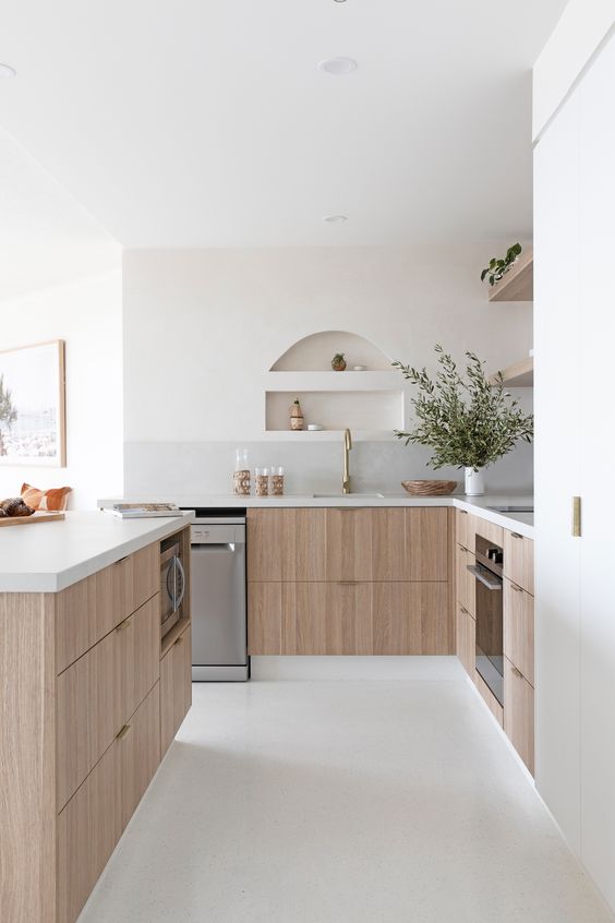 a calm, modern kitchen with stained base cabinets, stone countertops, open shelving and small nooks above the sink for storage