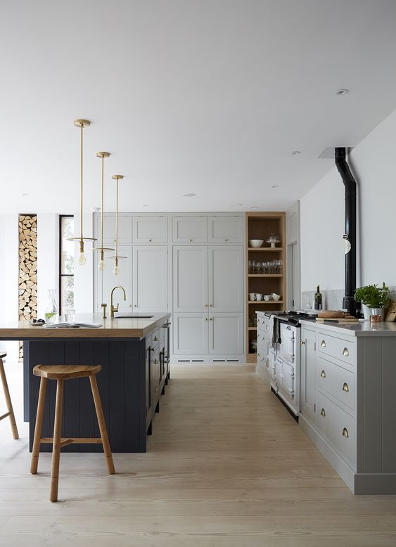 a traditional dove gray kitchen, a navy blue kitchen island with a wooden worktop and matching wooden stools