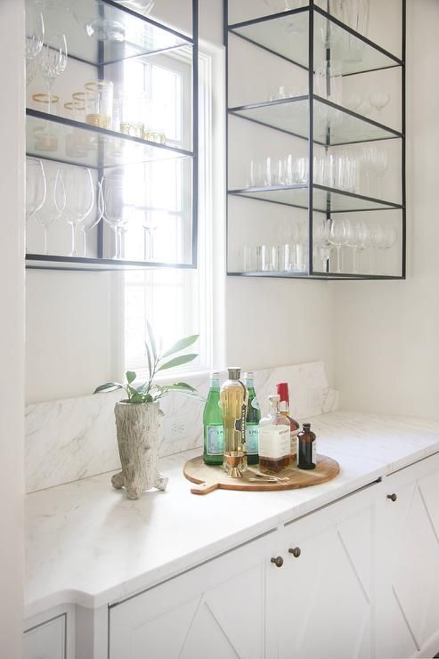 A stylish white kitchen with inlaid cabinets, black metal and hanging glass shelves is a catchy and stylish idea