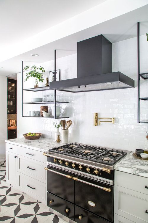 a sleek black and white kitchen with shaker cabinets, black appliances, and black hanging shelves instead of upper cabinets