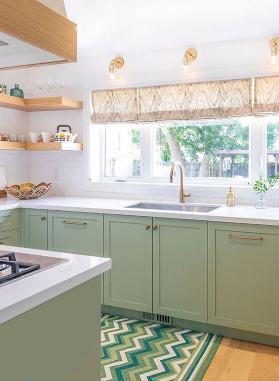 a modern farmhouse kitchen with shaker cabinets, white stone countertops, open corner shelving, and gold and brass fixtures