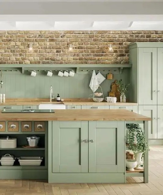 a sage green farmhouse kitchen with a beadboard backsplash and butcher block countertops, a large kitchen island with storage compartments