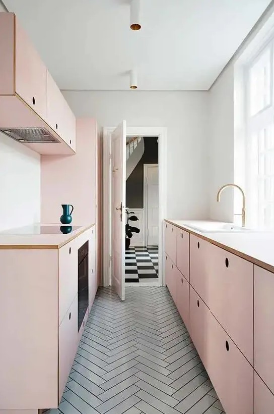 a chic, girly kitchen with simple blush plywood cabinets and a gray tile floor flooded with lots of natural light