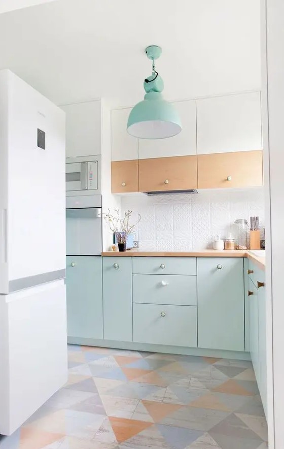a Scandinavian kitchen with white, stained and mint blue cabinets, a white textured backsplash, stained countertops and a geofloor