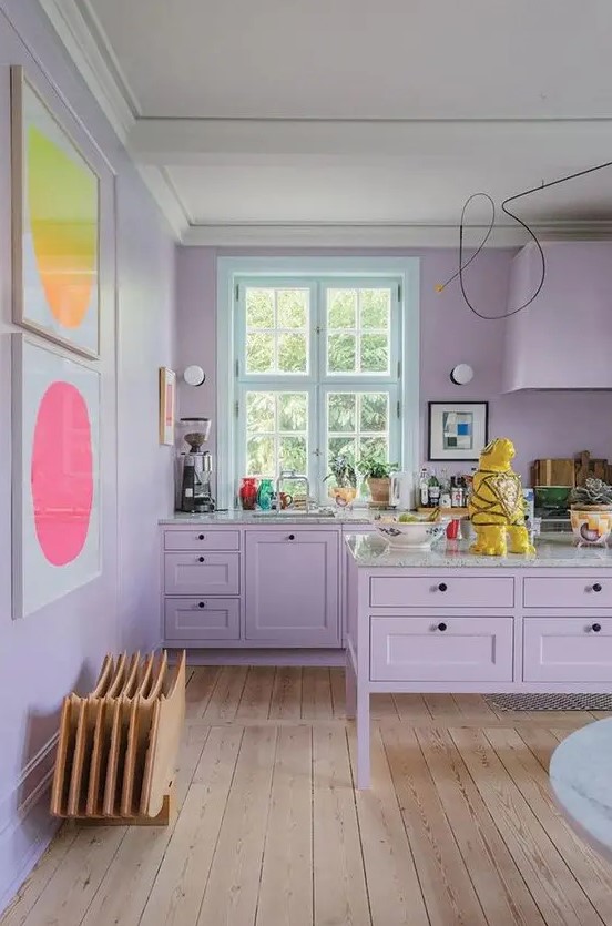 A soft purple kitchen with bright abstract artwork is a very girly and inviting space