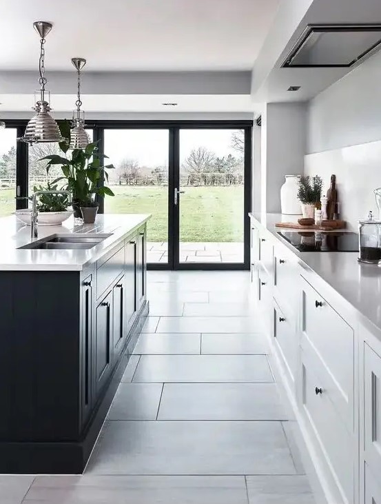 a modern kitchen with white cabinets and a black kitchen island, as well as the same countertops for both