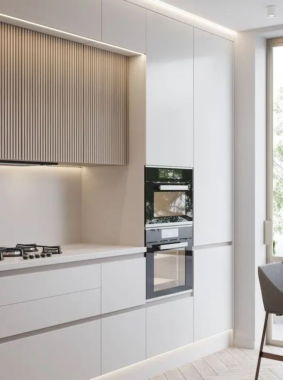 A minimalist white kitchen with sleek cabinets and light stained ribbed upper cabinets with lights is a beautiful idea